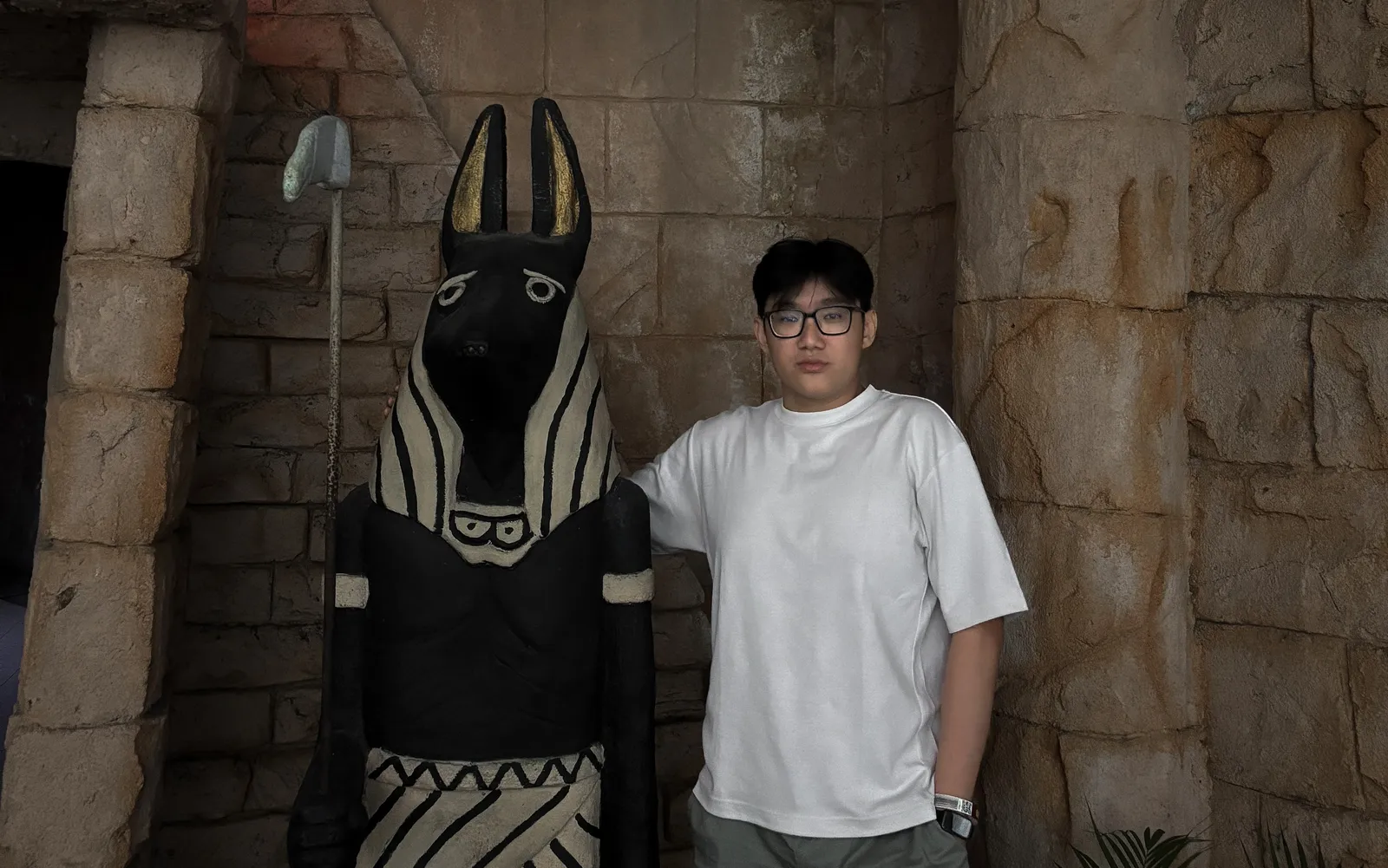 Alvin standing beside an Anubis statue